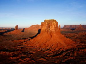 This image has a sky line background with sand stones