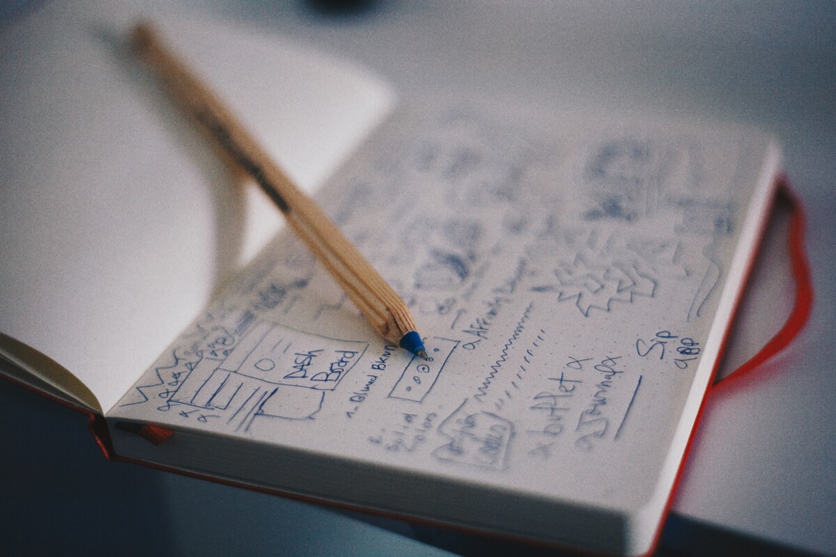 This is a stock image of a notebook with notes and a pencil