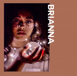 A photo of a girl placed on a brown border. The text to the right of the photo is white and says "BRIANNA".