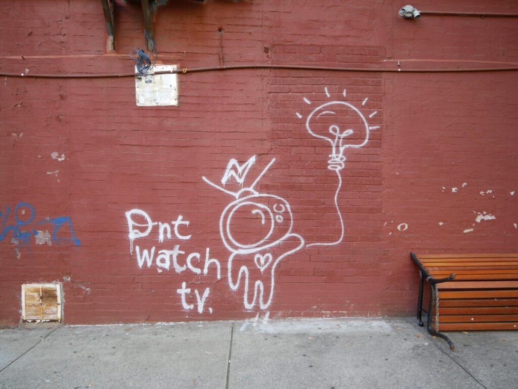 Space man graffiti with the writing "Dnt watch tv."