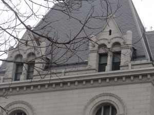The arches and spires of the top floor windows of the Bankruptcy Court (which also have the lion motif)