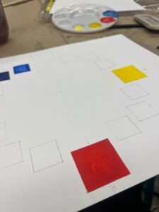 A white paper with red yellow and blue squares Description automatically generated