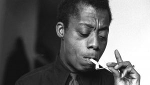 Baldwin lighting a cigarette