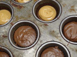 Filled peanut butter cups waiting for their final coat of chocolate.