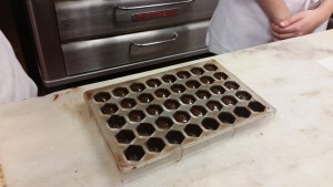 The mold has been filled with chocolate ganache and will be chilled and finished with another layer of tempered chocolate to crate a foot. 