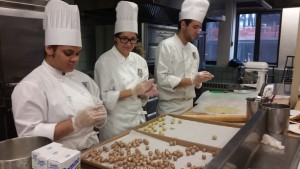 Team A: Ginette, Annalise and Felipe hand rolling the layers of the Mozart Kuglin. 
