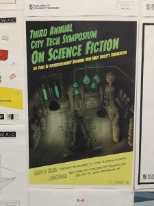 Scifi Symposium poster placed on our poster wall in the office.