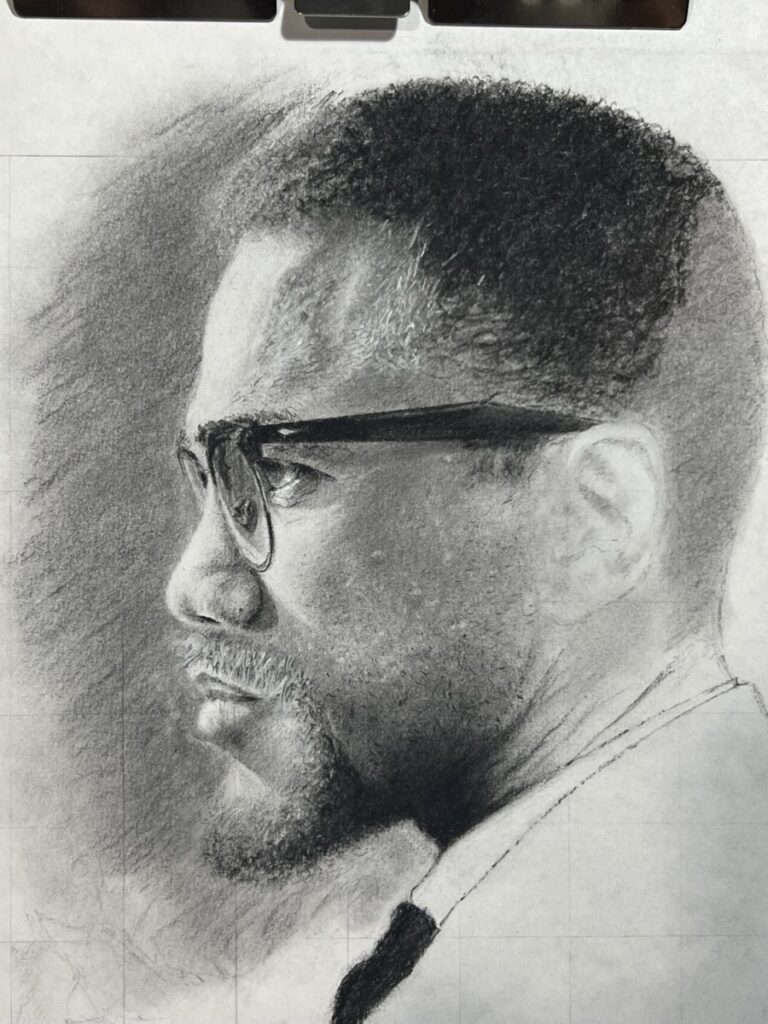 Charcoal drawing of Malcolm X concentrating intensely side profile.