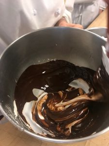 Adding melted chocolate to meringue