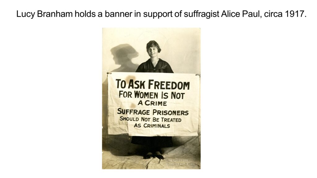 Lucy Branham holds a banner in support of suffragist Alice Paul, circa 1917.