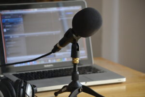 microphone and laptop to represent podcasting