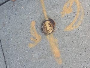 This image is a gas pipe line of a mark line. It was found on a sidewalk. It's a geometric shape because you can see clearly what it is.