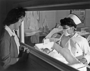 Ansel Adams, Nurse Hamaguchi presents a baby to her mother, Manzanar Relocation Center CA, 1943