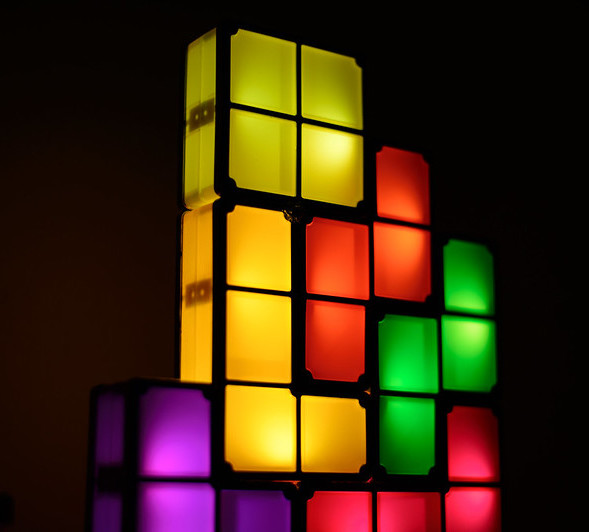 Multicolored blocks lit up in a dark space.