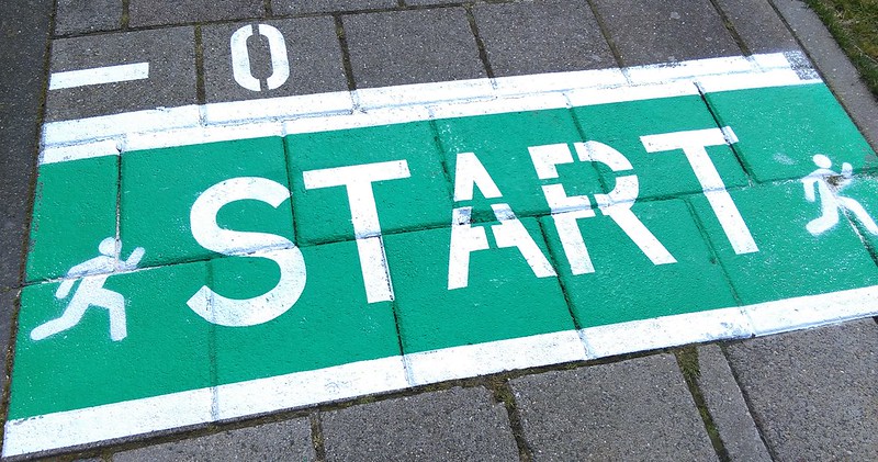 START sign painted on paving squares, with runner icons