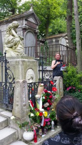 Olga giving a tour at Pere La Chaise Cemetery. She is standing next to Chopin's tomb. 