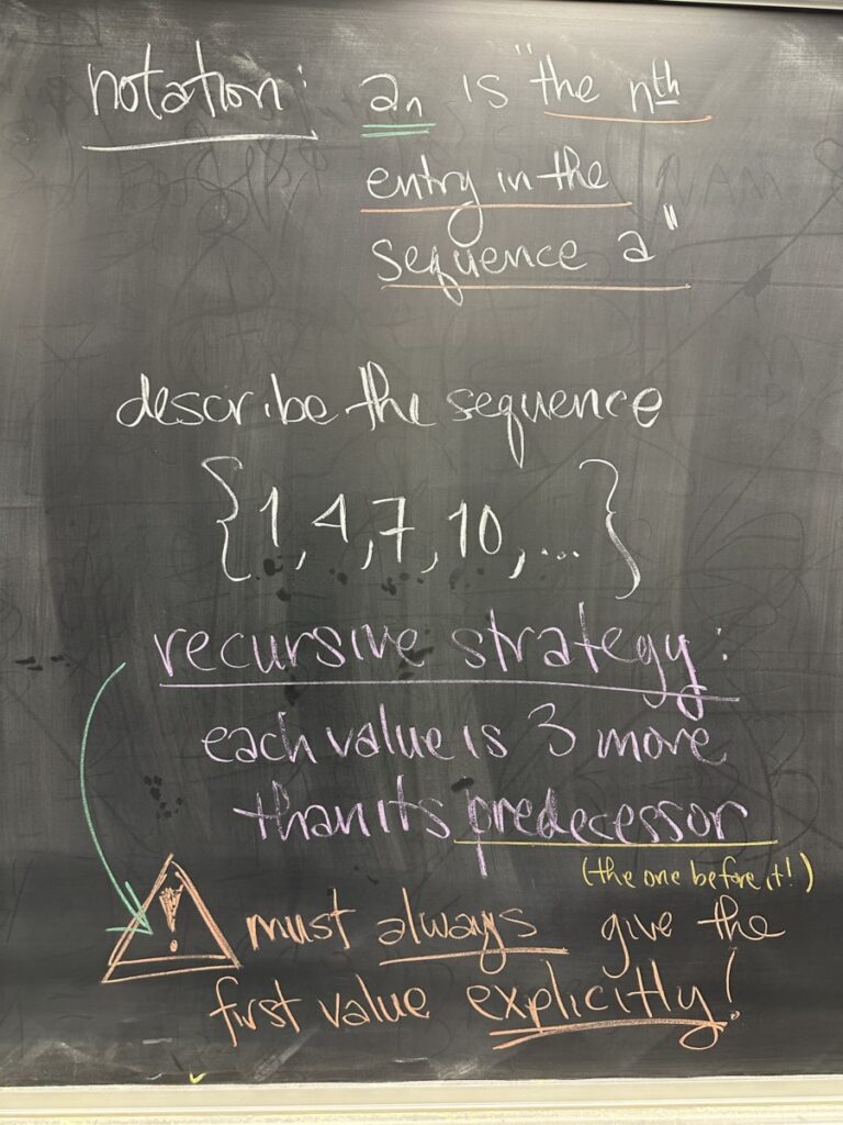 A photo of math written on a blackboard.