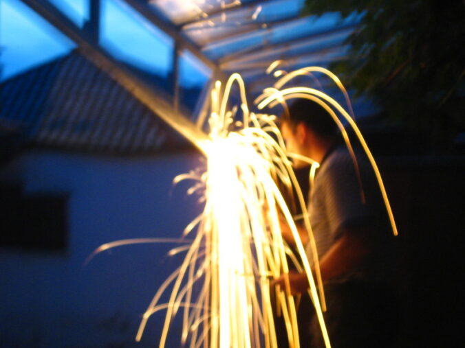 person working creating large sparks