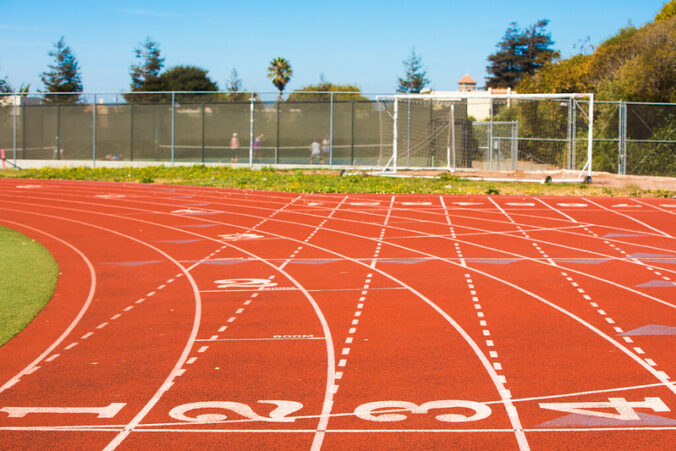 outdoor track with lanes numbered 1, 2, 3, and 4