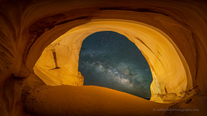 Cave shape with the Milky Way in the arched opening