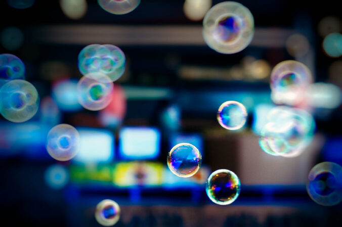 soap bubbles floating in front of screens