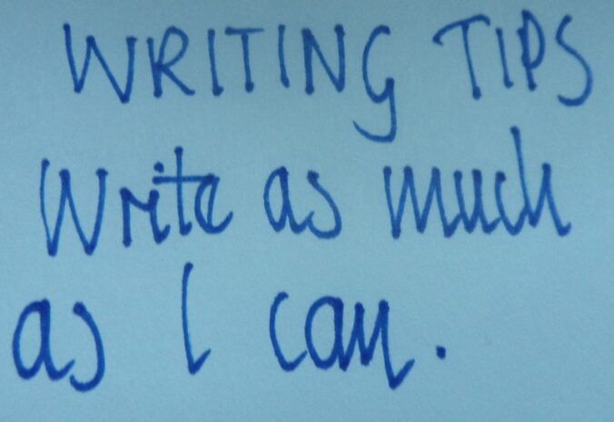 Blue ink on light blue page reads "Writing Tips Write as much as I can."