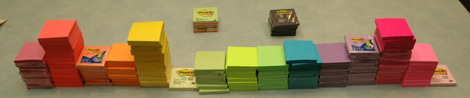 piles of post-it pads in different colors