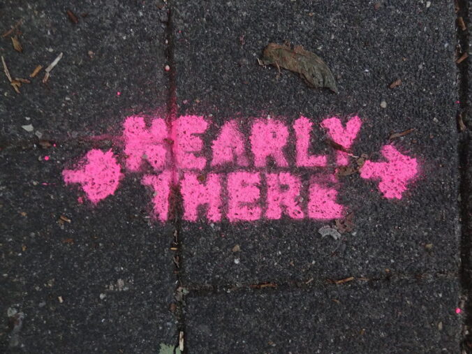 black background with "nearly there" and arrows in pink paint