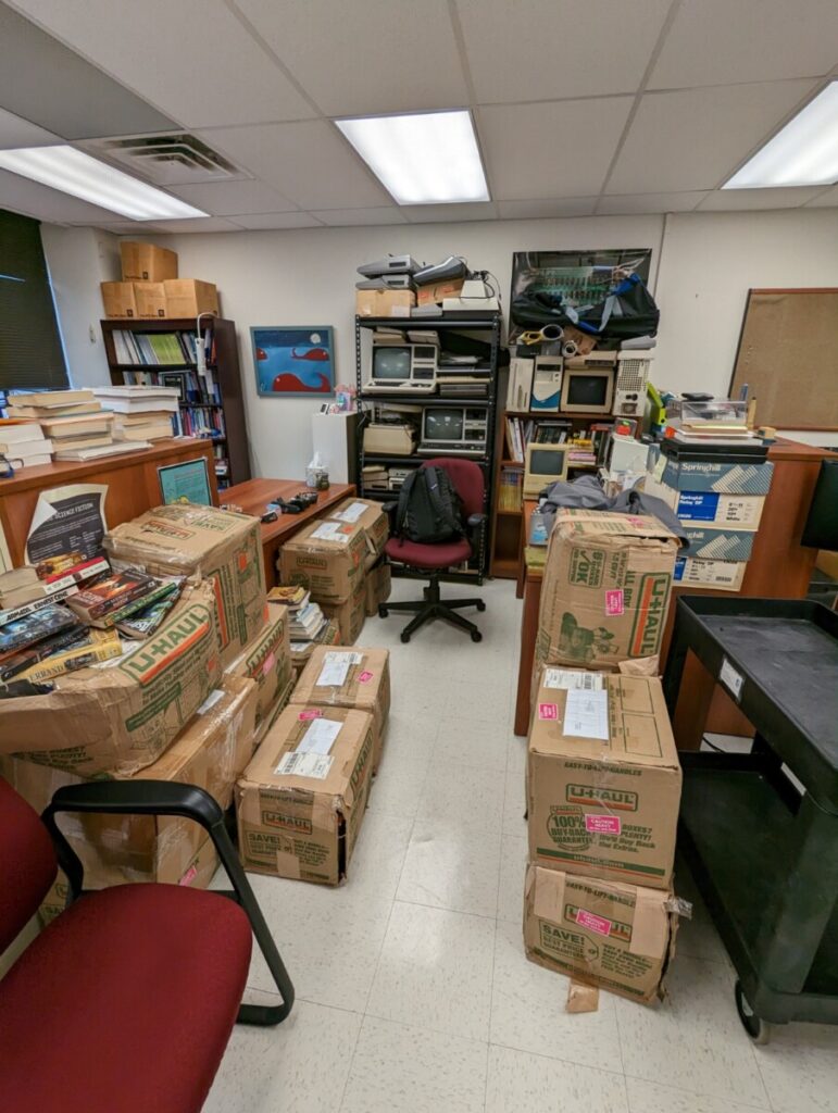Jason Ellis' office space full of donated SF material in boxes.
