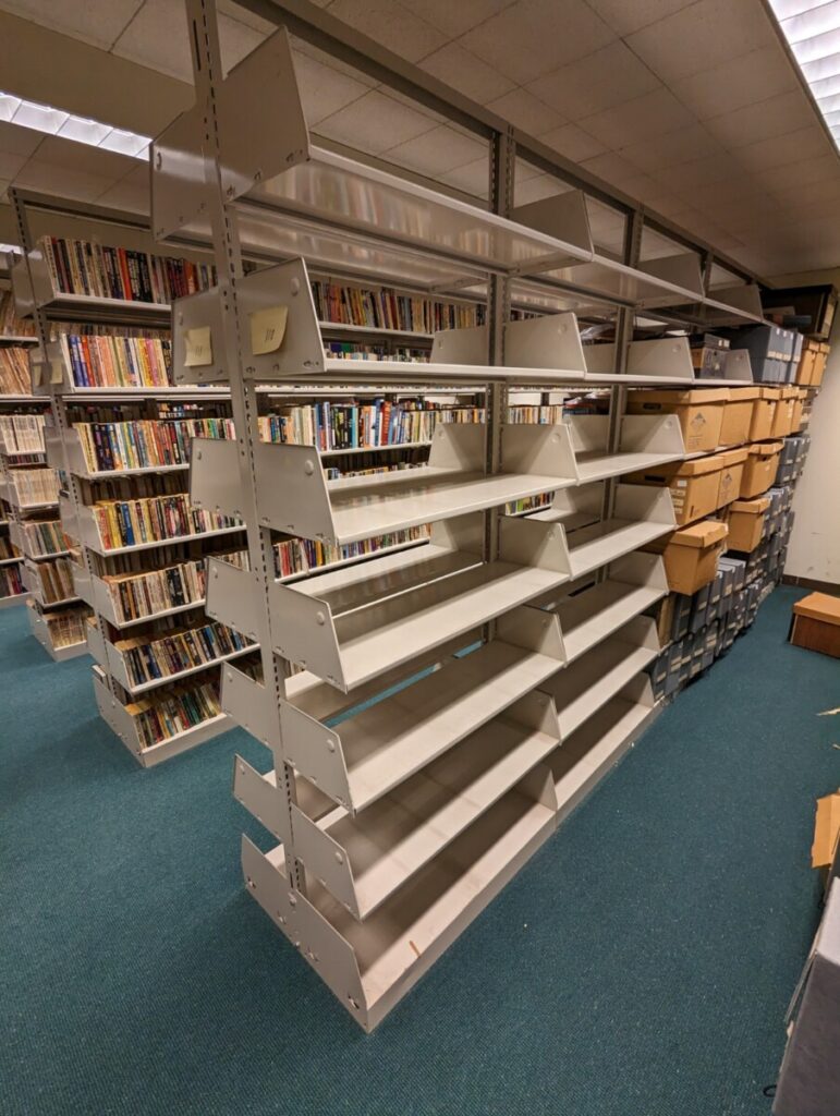 Four empty stacks adjacent to the City Tech Science Fiction Collection in the Special Collections and Archives Room of the Library.