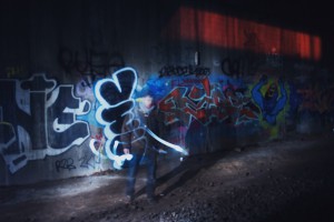 a person standing in front of graffiti