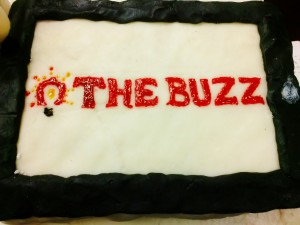 a decorated cake made for "The Buzz" team