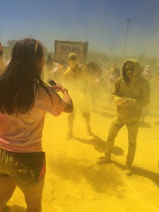 people in clouds of colored, smokey paint