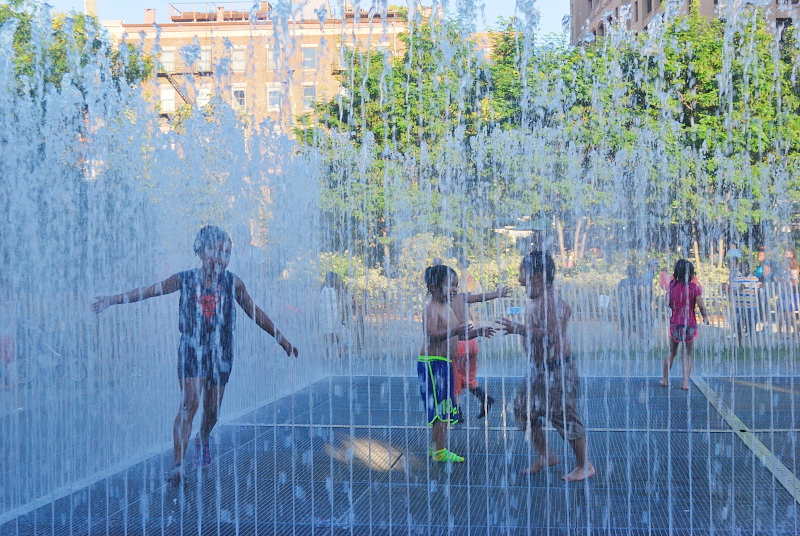kids playing in a park fountain