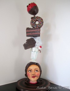 a topsy-turvy themed caked of towering sweets