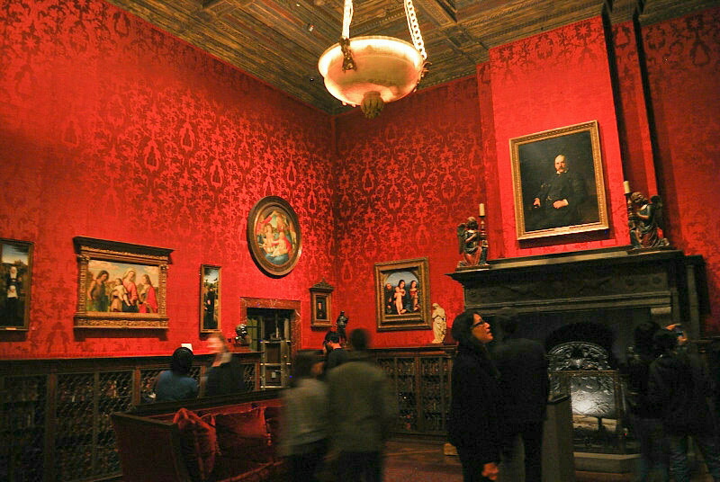 an old-fashioned room with red wallpaper
