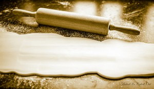 rolling pin and a rolled out piece of dough