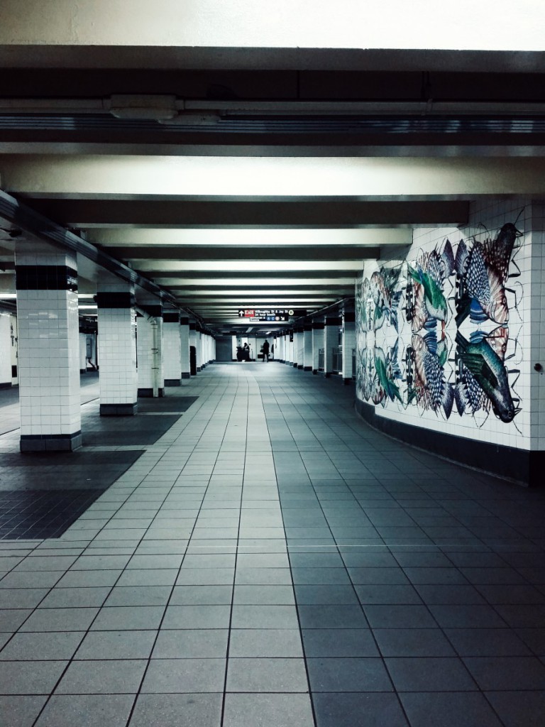 a subway platform with tile art