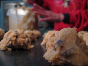 cookie dough being placed on a sheet pan