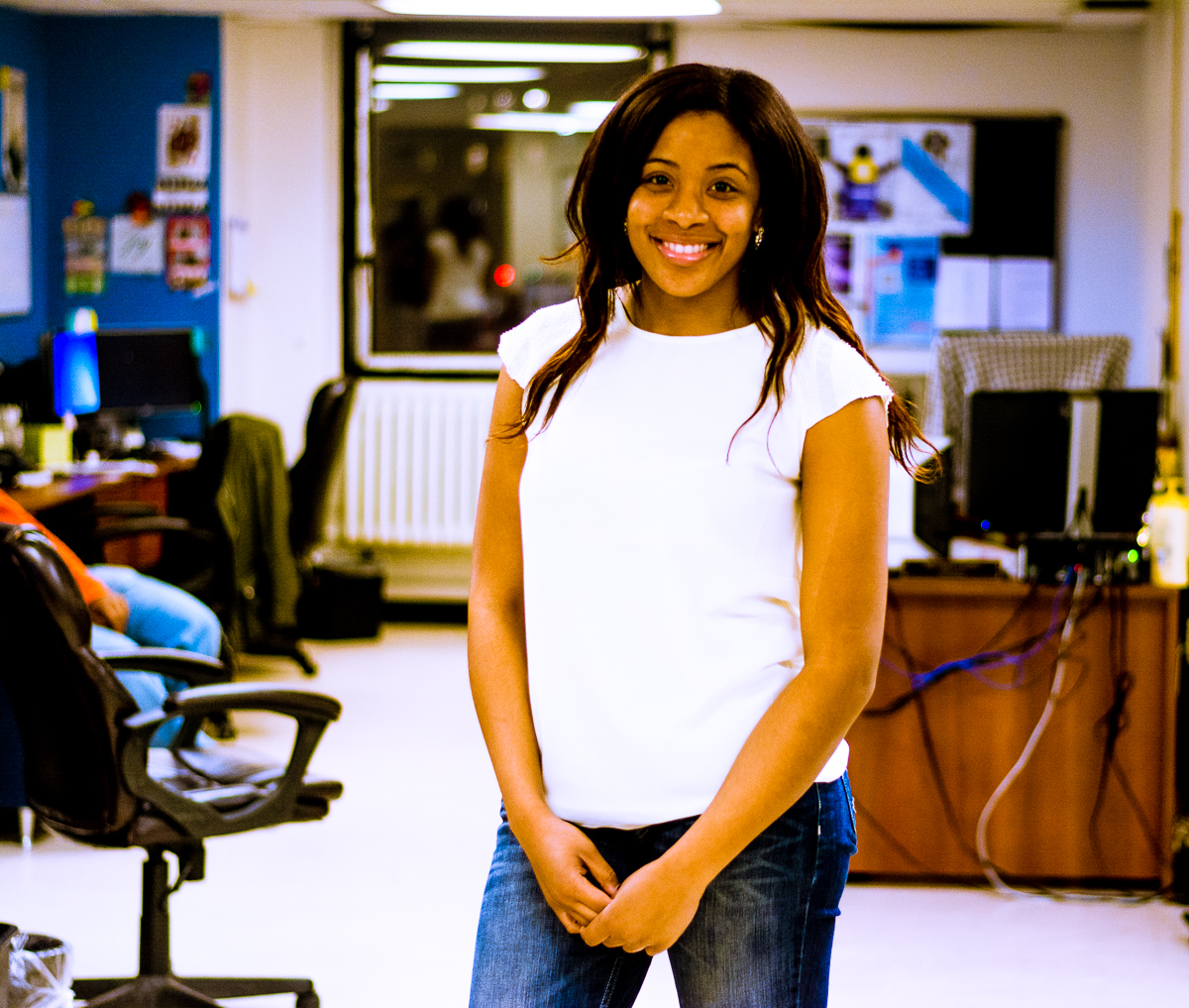 a smiling woman in jeans and a white T-shirt