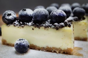fresh blueberries on top of a plain cheesecake