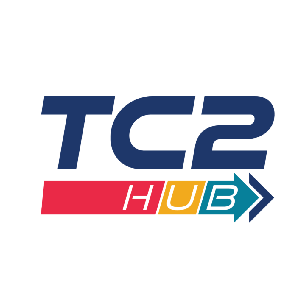 TC2 hub logo in dark blue with a line underneath moving forward with an arrow . The line is broken into three sections with a red with an H, yellow with a U, and teal with a B for the word hub.