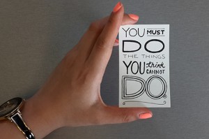 a card that says "You must do the things you think you cannot do"