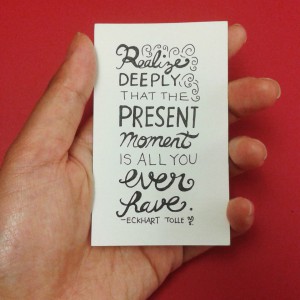 a card that says "Realize deeply that the present moment is all you ever have -Eckhart Tolle"