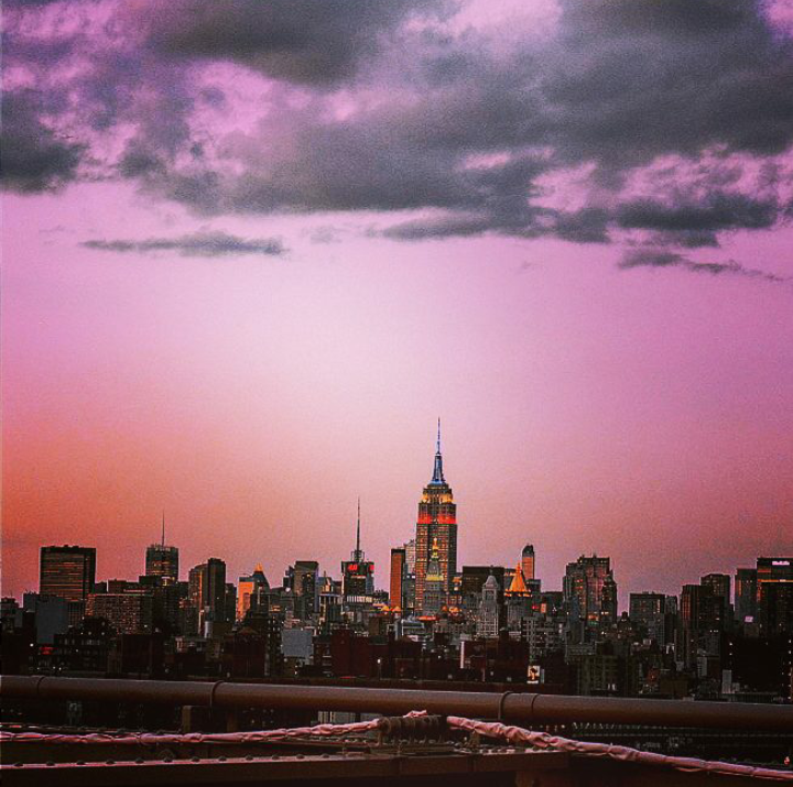 a purple sunset over a city skyline