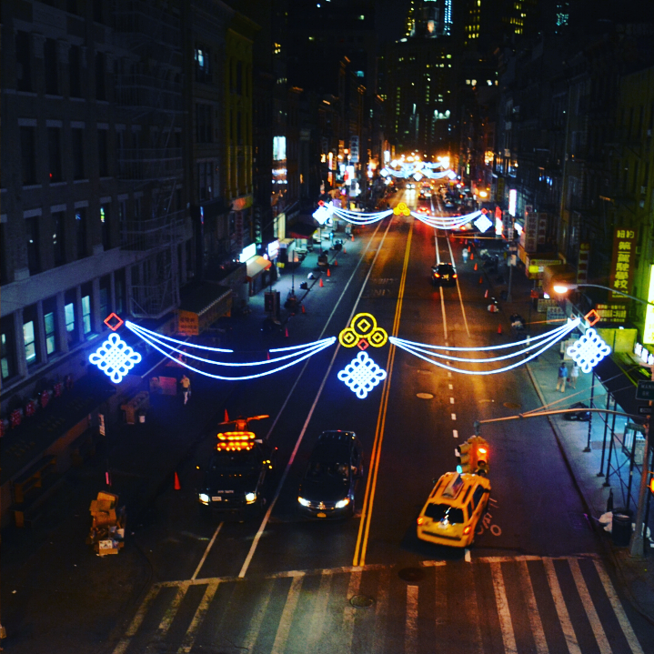 strung lights across a city street at night
