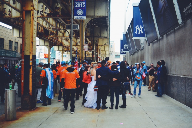 bride and groom on a crowded sidewalk