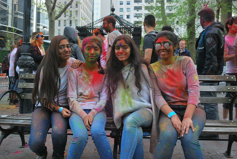 Four young women covered in paint splashes