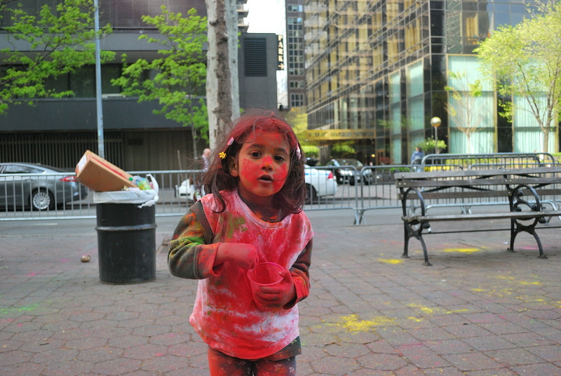 a young girl covered in paint