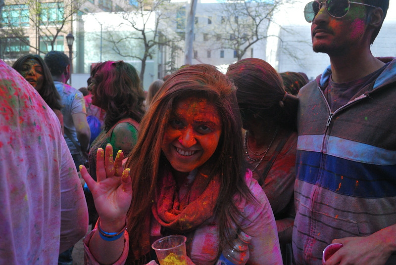 a young woman covered in orange paint